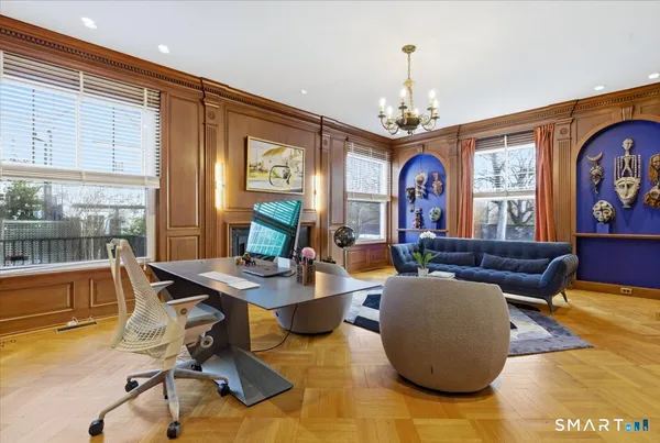 a view of a dining room with furniture a chandelier and wooden floor