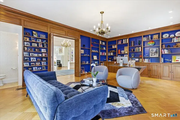 a dining room with wooden floor and large windows
