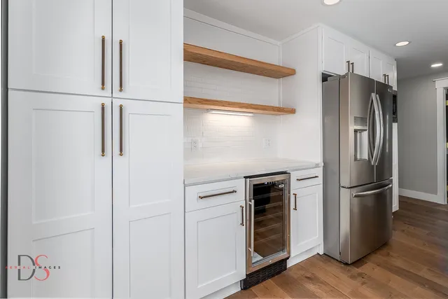 a metallic refrigerator freezer sitting in a kitchen