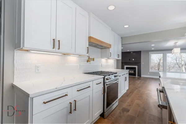 a kitchen with stainless steel appliances granite countertop a sink and a stove top oven