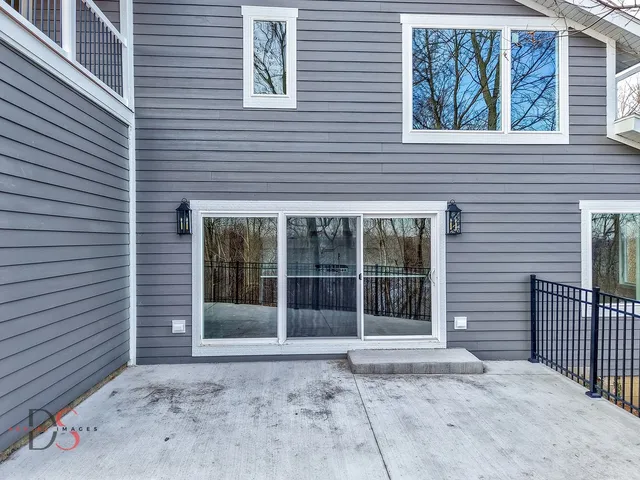 a front view of a house with a window and garden