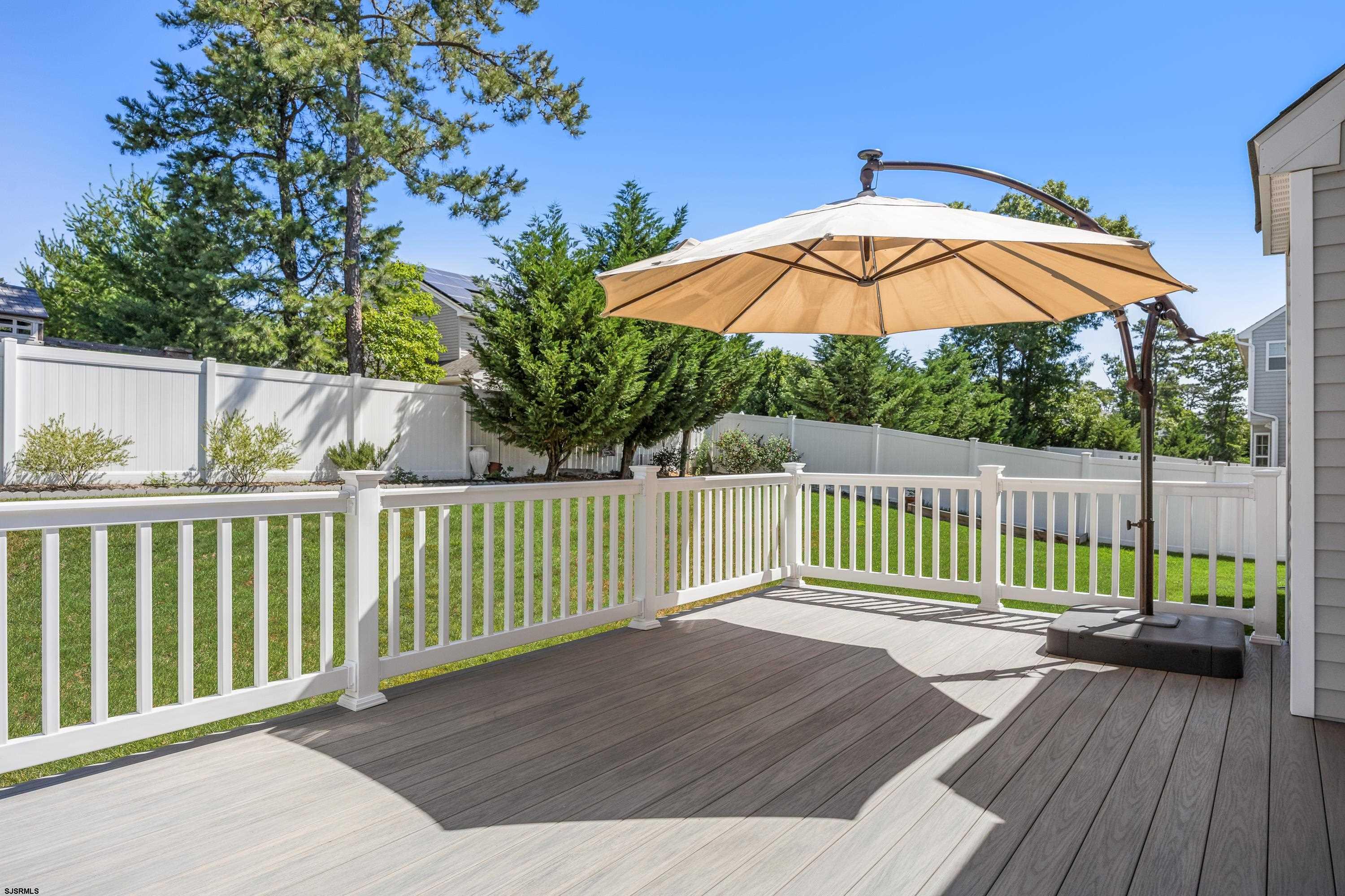 215 Surf Road Egg Harbor Township, NJ 08234 - Photo 27 of 31 a view of a wooden deck with a small yard