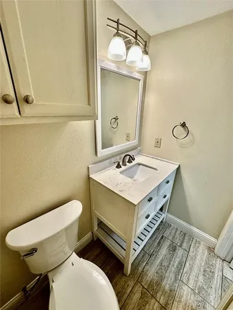 a bathroom with a sink a toilet and mirror