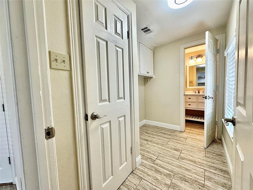 6632 Winding Rose Trail Dallas, TX 75252 - Photo 12 of 23 a view of a hallway with wooden floor and staircase