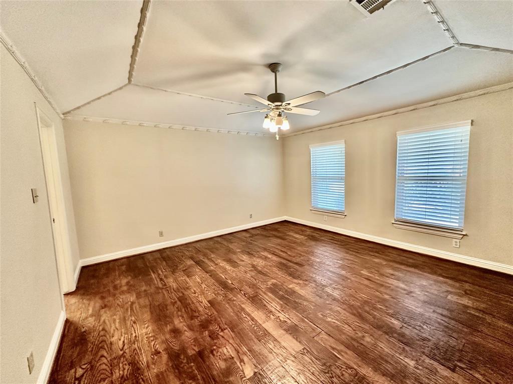 6632 Winding Rose Trail Dallas, TX 75252 - Photo 17 of 23 an empty room with wooden floor fan and windows