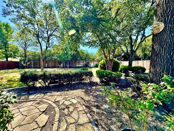 a swimming pool with outdoor space and trees in the background