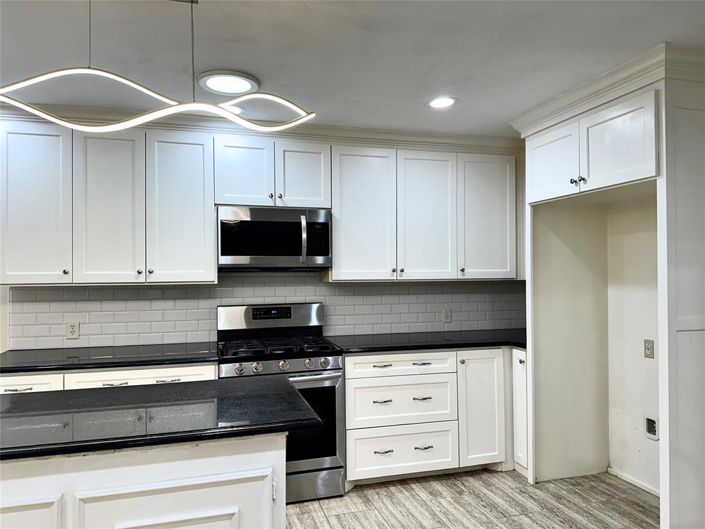 6632 Winding Rose Trail Dallas, TX 75252 - Photo 10 of 23 a kitchen with granite countertop a sink a stove and cabinets