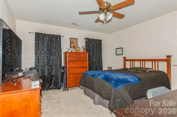 a bedroom with a bed and a dresser