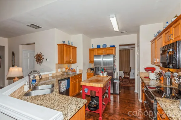 a large kitchen with a table and chairs