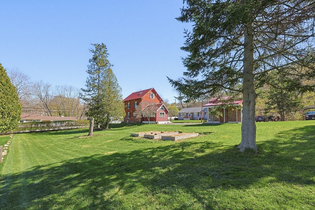 44 Clark Street Spencer, MA 01562 - Photo 4 of 41 a swimming pool is sitting in the grass near a big yard