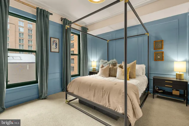 a bedroom with a bed table and a window