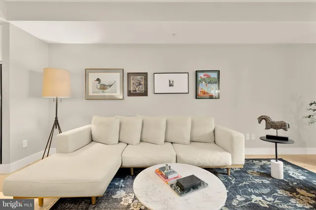 a living room with furniture and a lamp