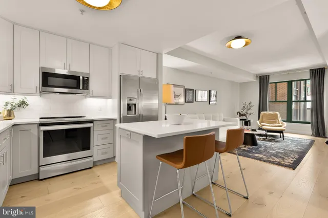 a kitchen with a stove a sink and a refrigerator