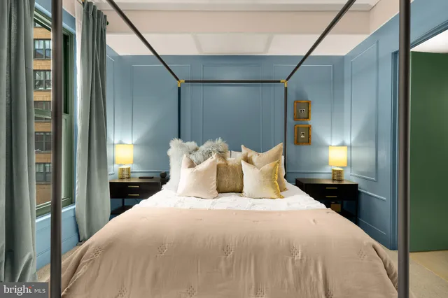 a bedroom with a bed and a lamp