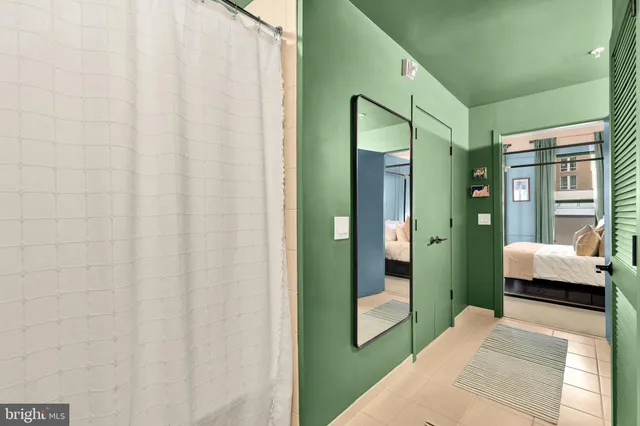 a bedroom with a bed and a mirror