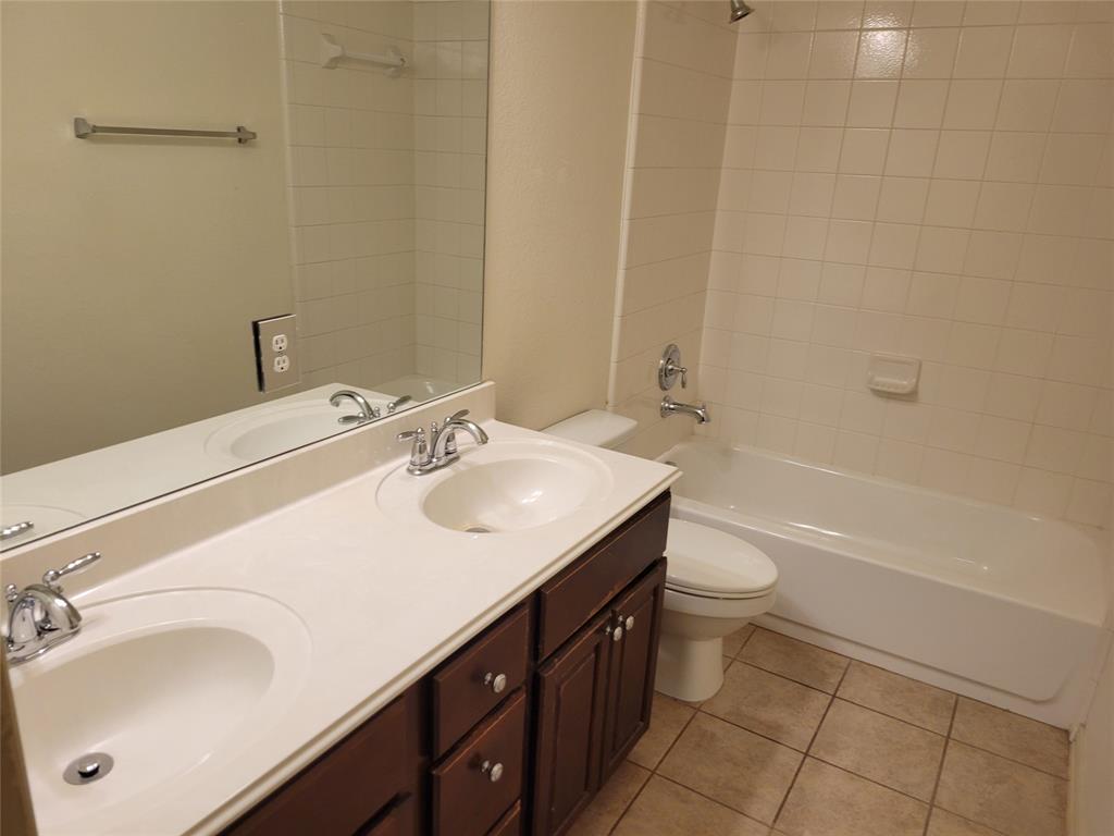 508 Hummingbird Drive Little Elm, TX 75068 - Photo 13 of 14 a bathroom with a sink toilet and shower