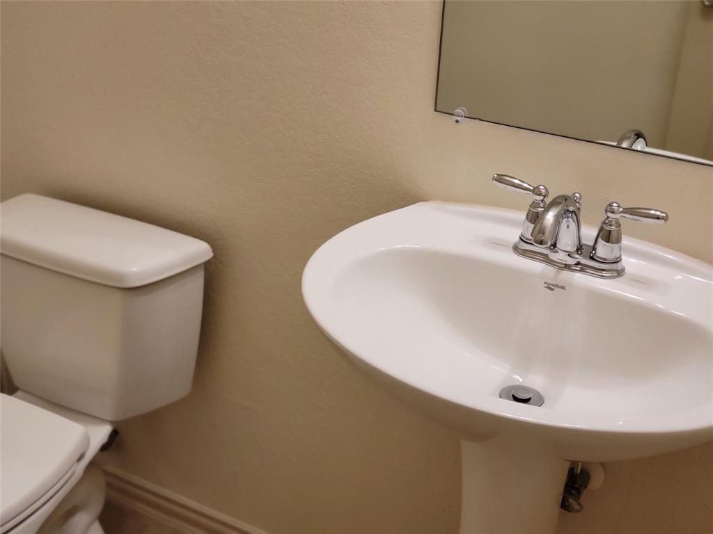 508 Hummingbird Drive Little Elm, TX 75068 - Photo 14 of 14 a bathroom with a sink and a toilet