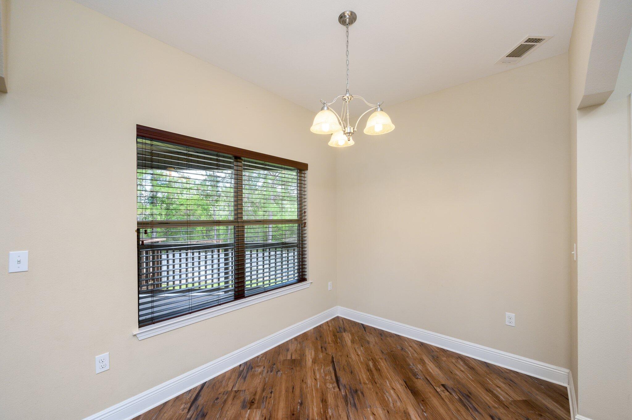 714 Lime Lane Crestview, FL 32536 - Photo 11 of 47 a view of a livingroom with a chandelier fan and a window