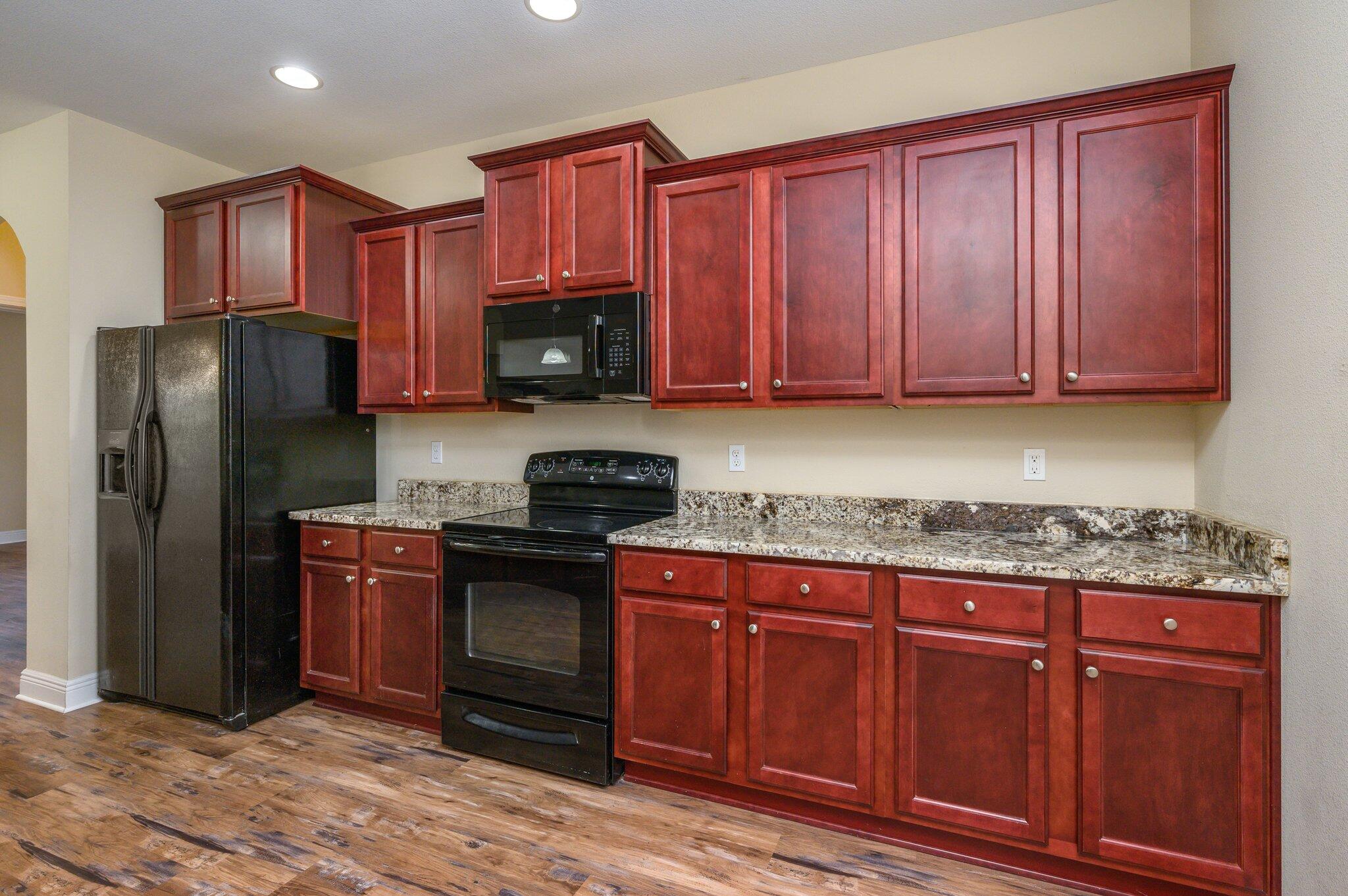 714 Lime Lane Crestview, FL 32536 - Photo 15 of 47 a kitchen with stainless steel appliances granite countertop a stove a refrigerator and a microwave