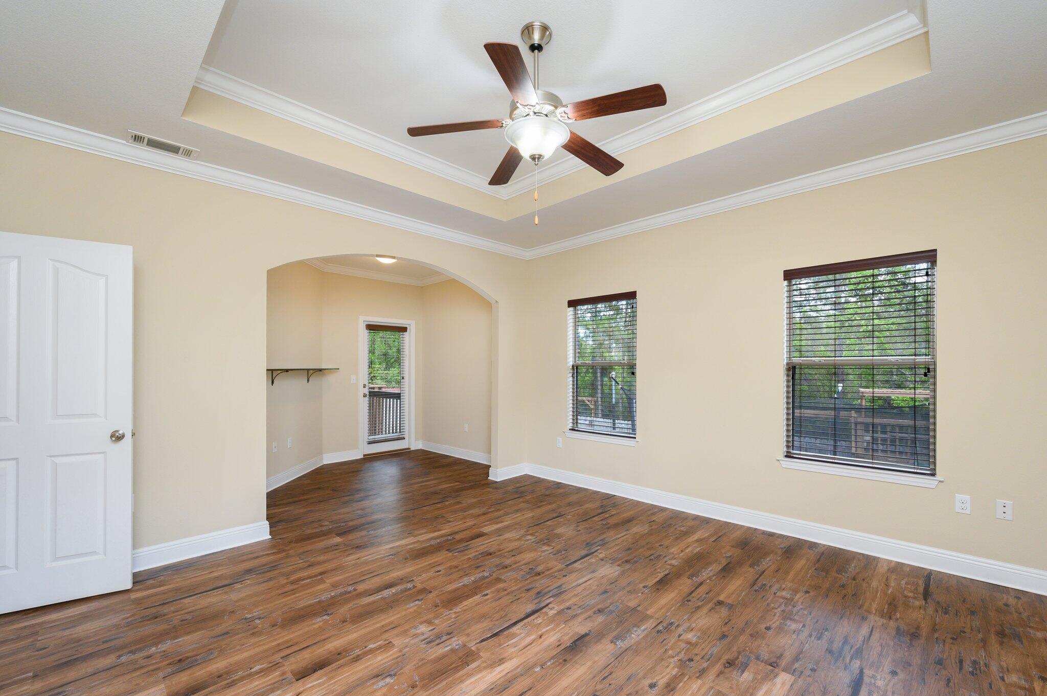 714 Lime Lane Crestview, FL 32536 - Photo 20 of 47 a view of an empty room with wooden floor and a window