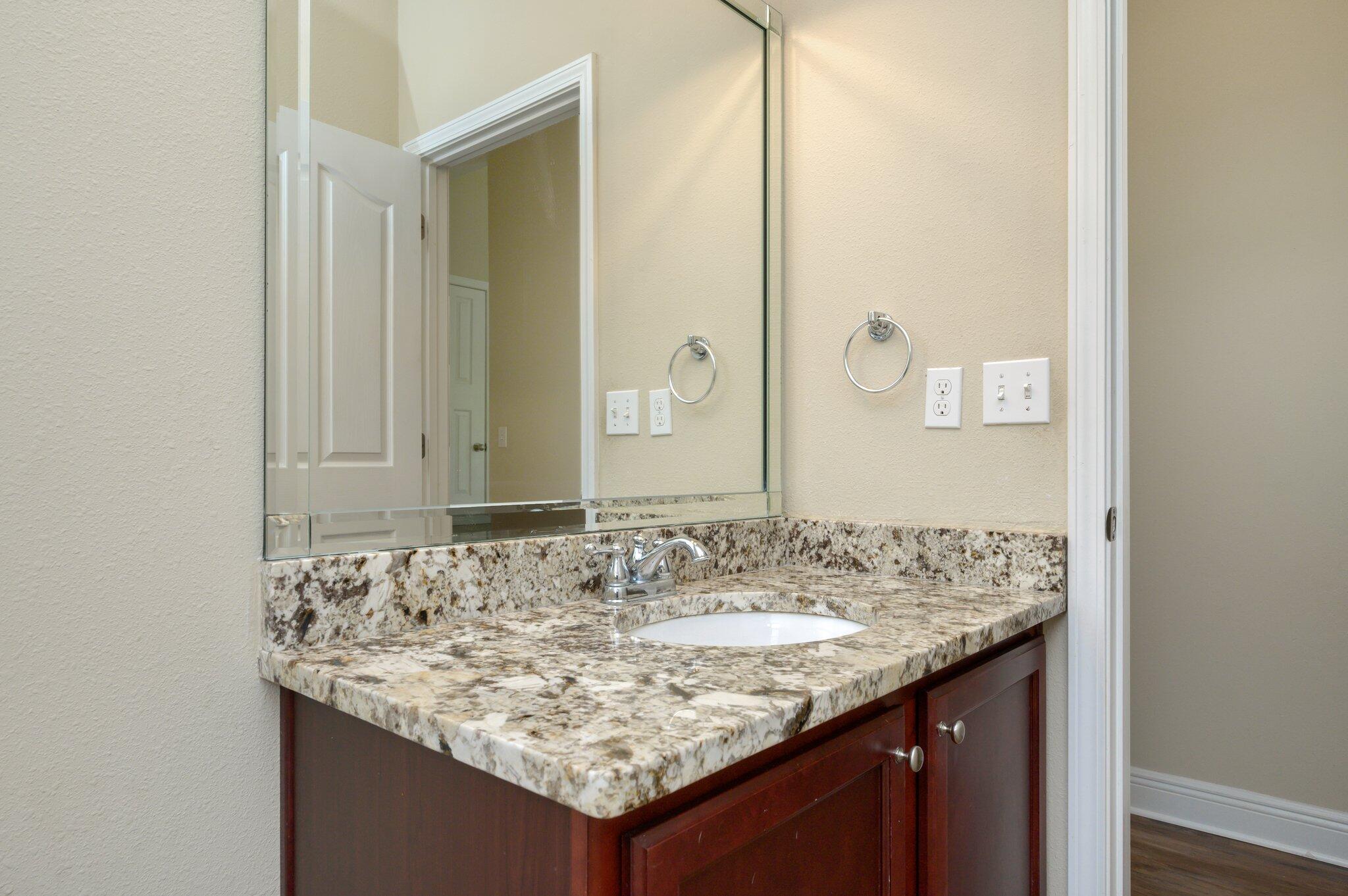 714 Lime Lane Crestview, FL 32536 - Photo 33 of 47 a bathroom with a granite countertop sink and a mirror