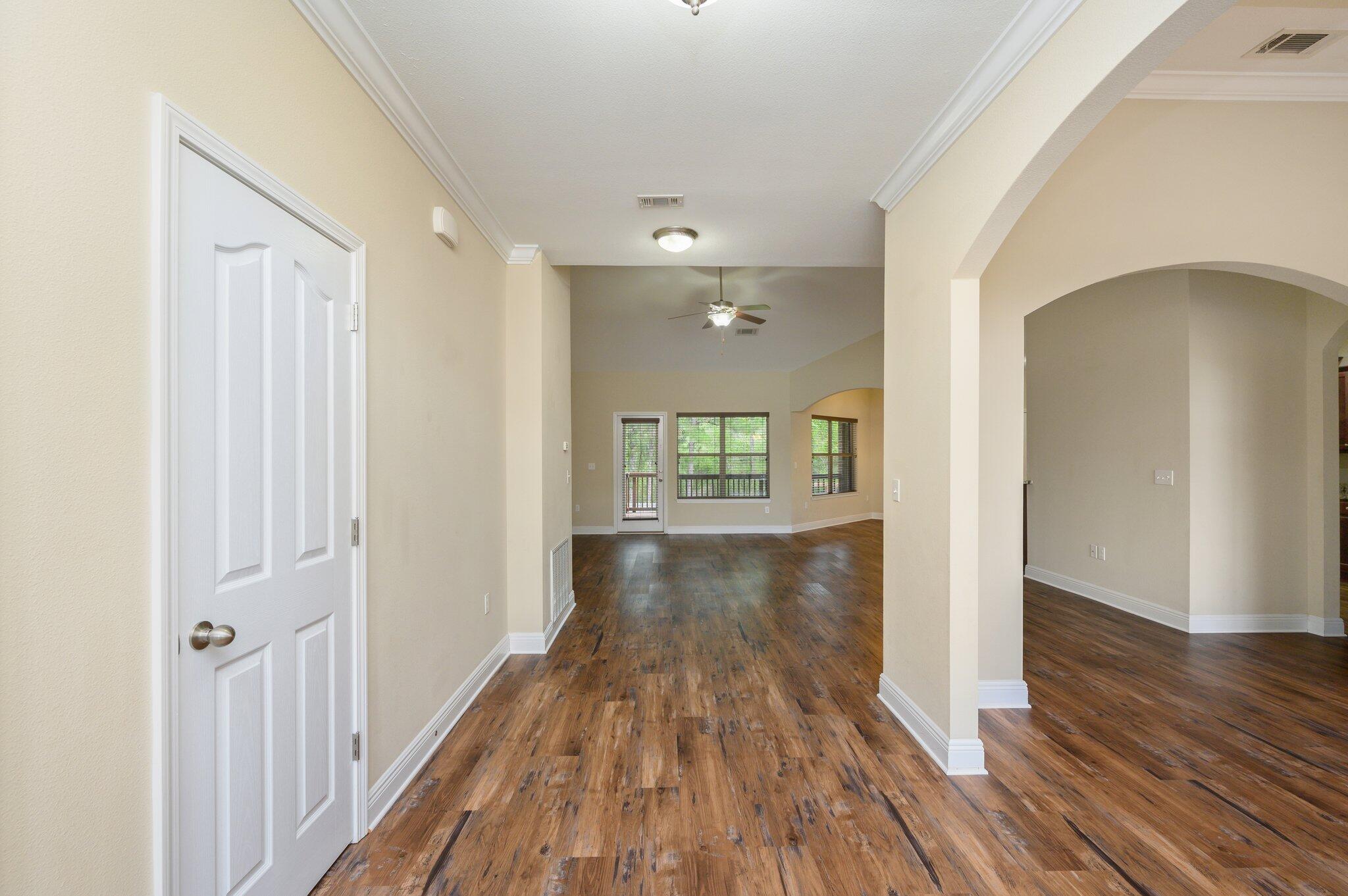 714 Lime Lane Crestview, FL 32536 - Photo 6 of 47 a view of a hallway with wooden floor and staircase
