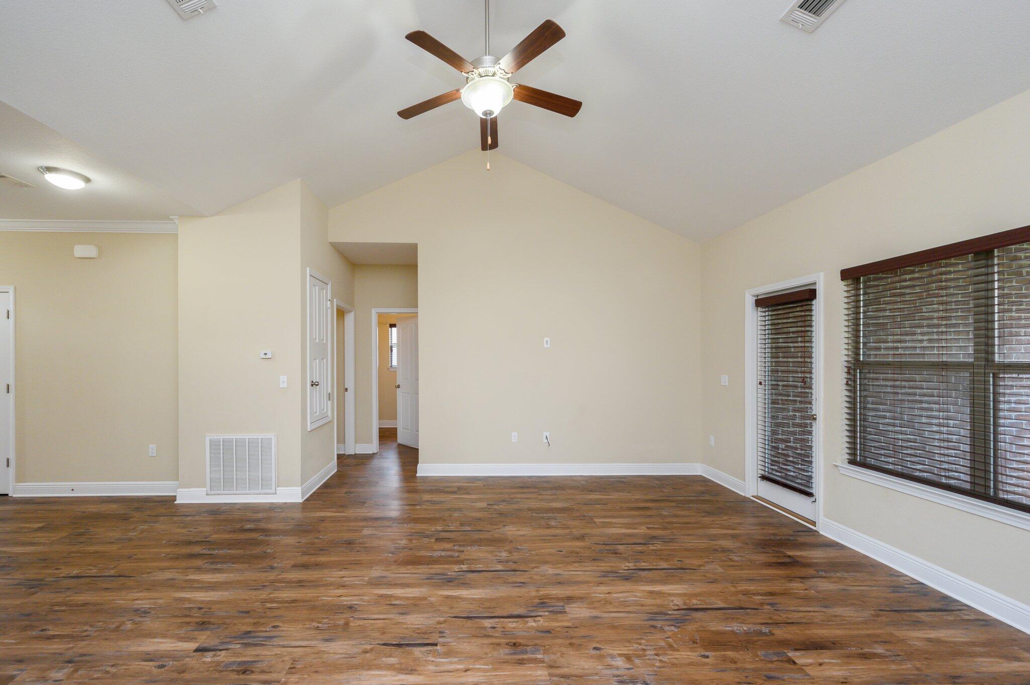 714 Lime Lane Crestview, FL 32536 - Photo 8 of 47 a view of a room with wooden floor and a ceiling fan