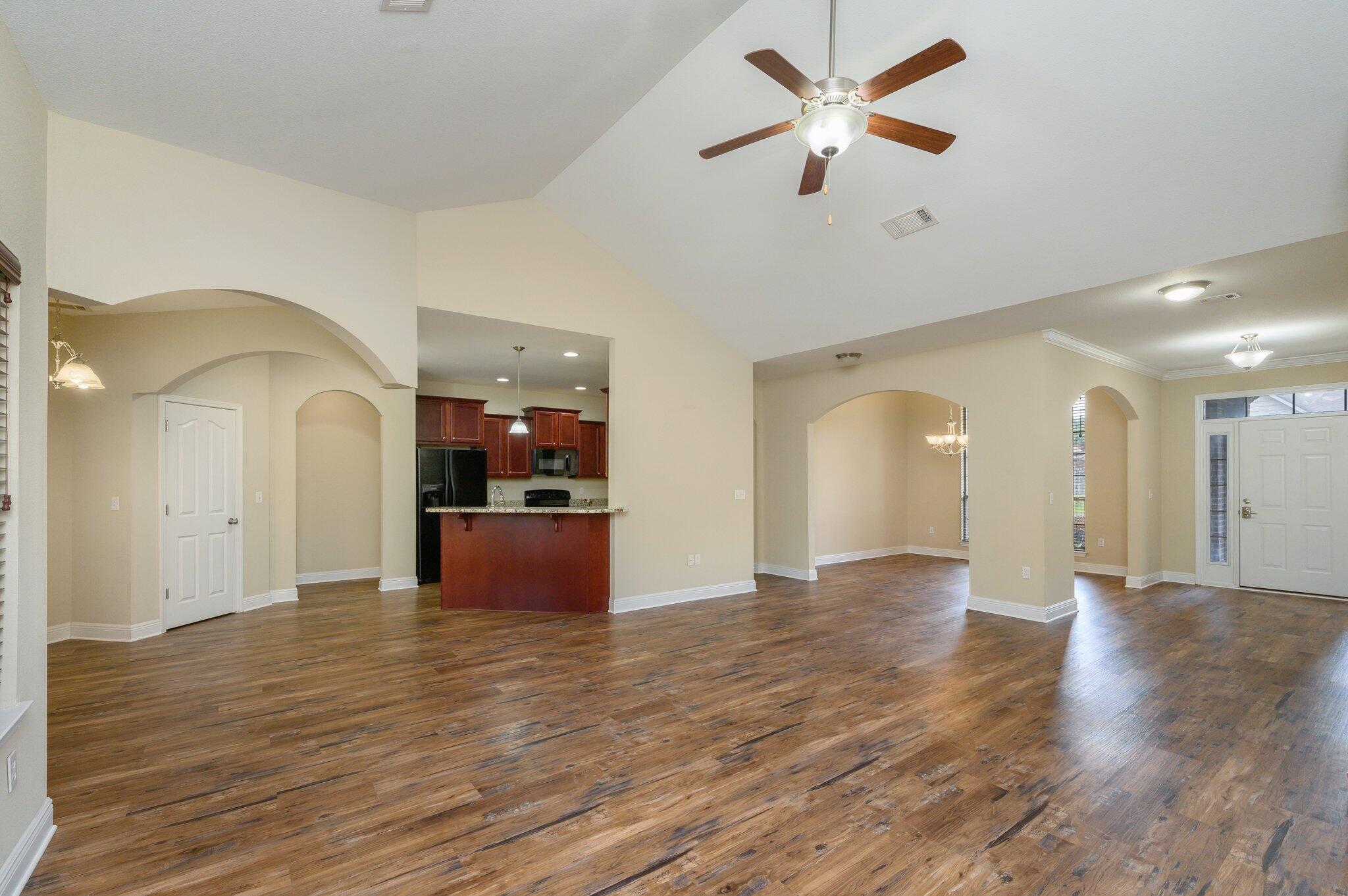 714 Lime Lane Crestview, FL 32536 - Photo 9 of 47 a view of a room with wooden floor and a ceiling fan