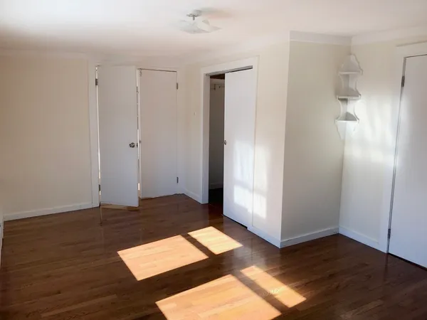 an empty room with wooden floor
