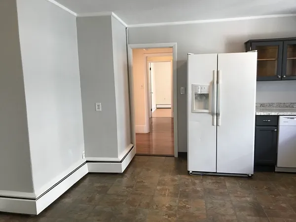 a view of a kitchen with refrigerator and cabinet