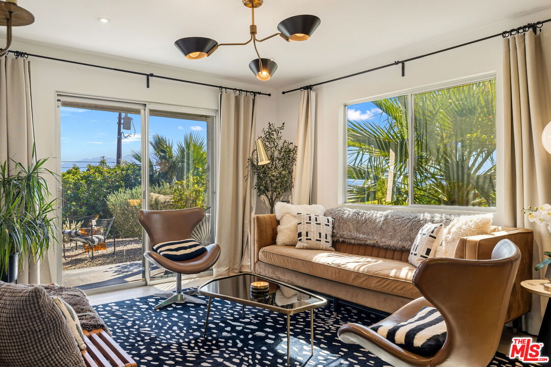66869 San Ardo Road Desert Hot Springs, CA 92240 - Photo 16 of 39 a living room with furniture and a large window
