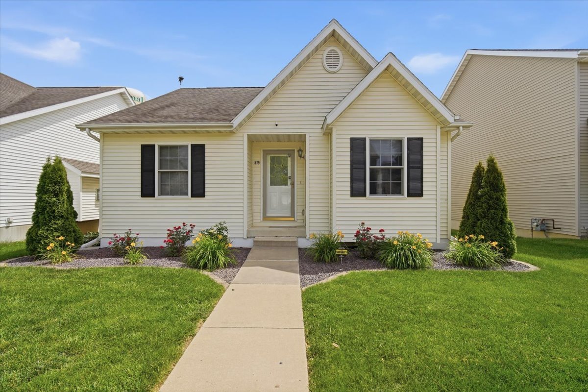 915 Teegan Street Normal, IL 61761 - Photo 1 of 33 a front view of a house with a yard and potted plants