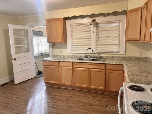 a kitchen with stainless steel appliances granite countertop a sink and a stove