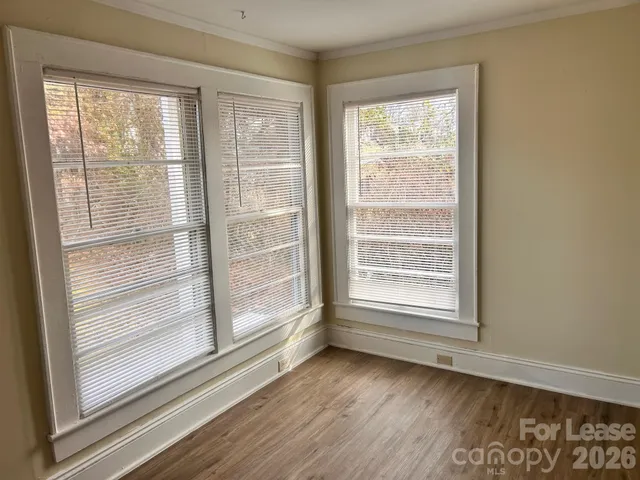 a view of wooden floor and windows in a room