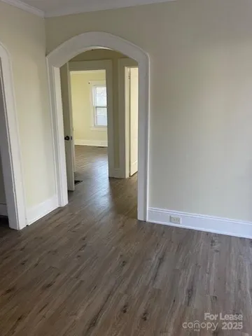 a view of a room with wooden floor and a window