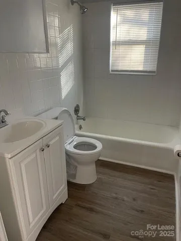 a bathroom with a sink toilet and window