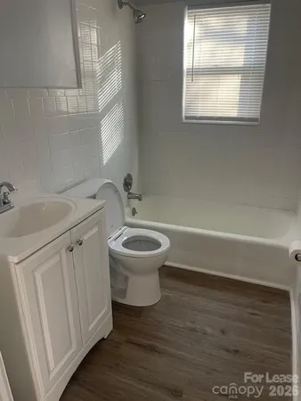 a bathroom with a sink toilet and window