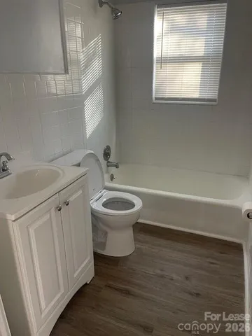 a bathroom with a sink toilet and window