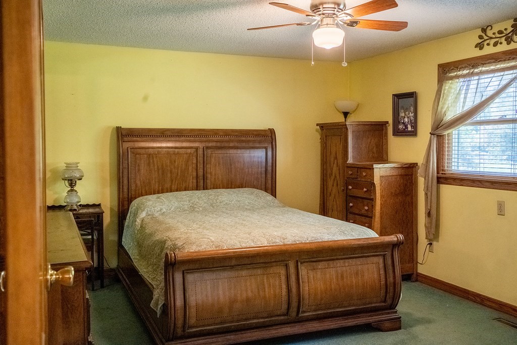 66 Rattle Hill Road Southampton, MA 01073 - Photo 8 of 25 a bed sitting in a bedroom next to a window