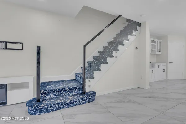 a view of a hallway view with staircase