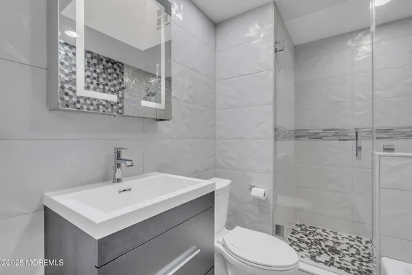 a bathroom with a sink toilet and shower
