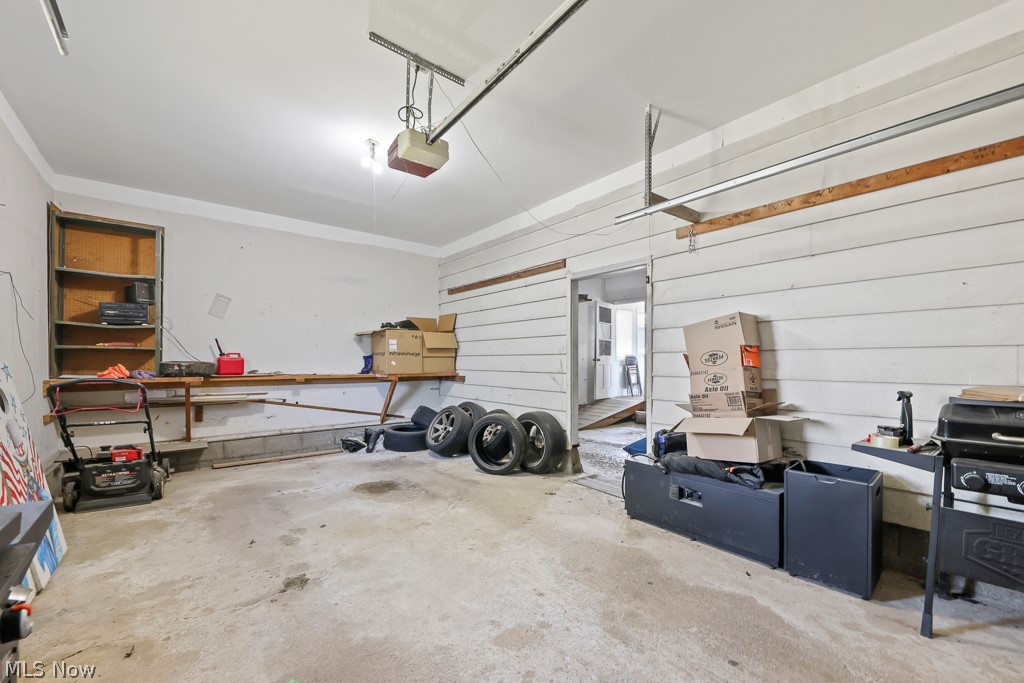 611 Herbert Road Akron, OH 44312 - Photo 30 of 30 Spacious garage featuring a concrete floor, built-in shelving, and direct interior access
