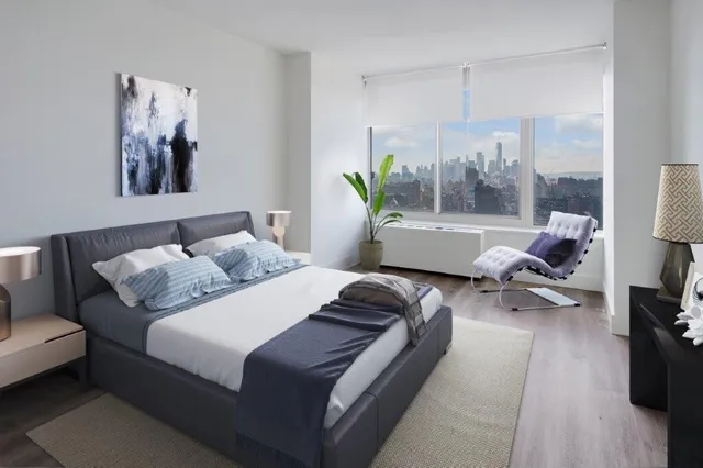 a bedroom with a bed and a potted plant