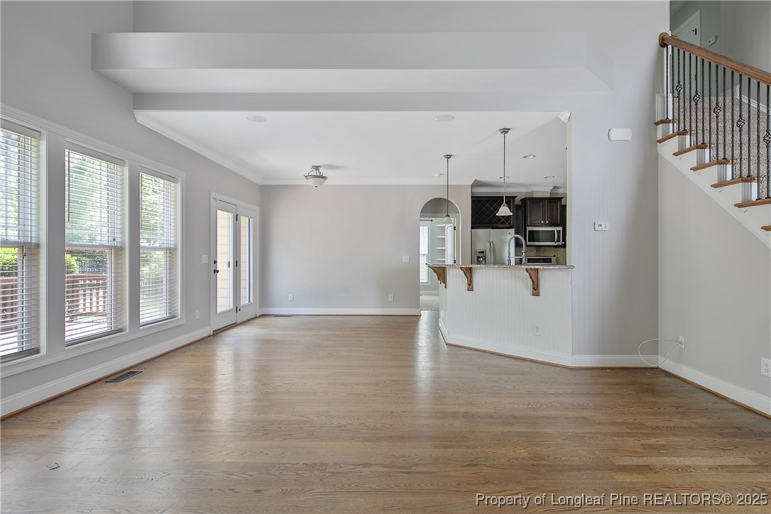 716 Micahs Way North Spring Lake, NC 28390 - Photo 11 of 50 a view of empty room with wooden floor and windows