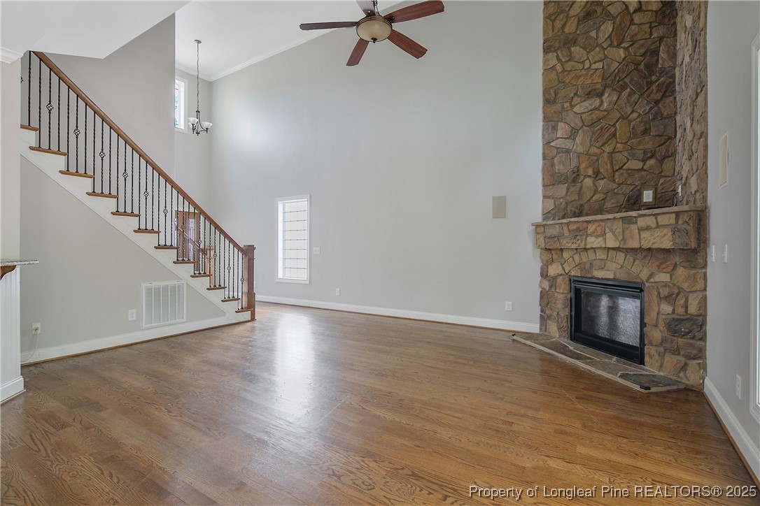 716 Micahs Way North Spring Lake, NC 28390 - Photo 13 of 50 a view of an empty room with wooden floor fireplace and a window