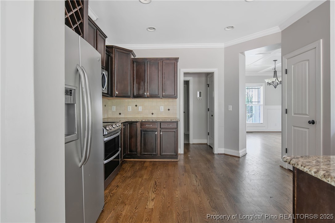 716 Micahs Way North Spring Lake, NC 28390 - Photo 18 of 50 a kitchen with stainless steel appliances granite countertop a refrigerator and a stove top oven