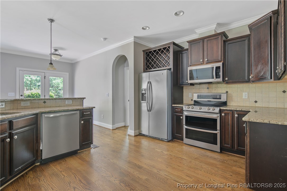 716 Micahs Way North Spring Lake, NC 28390 - Photo 21 of 50 a kitchen with stainless steel appliances granite countertop a refrigerator a stove a sink and a microwave