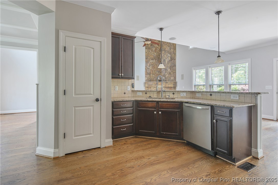 716 Micahs Way North Spring Lake, NC 28390 - Photo 23 of 50 a kitchen with stainless steel appliances granite countertop a sink a stove and a window