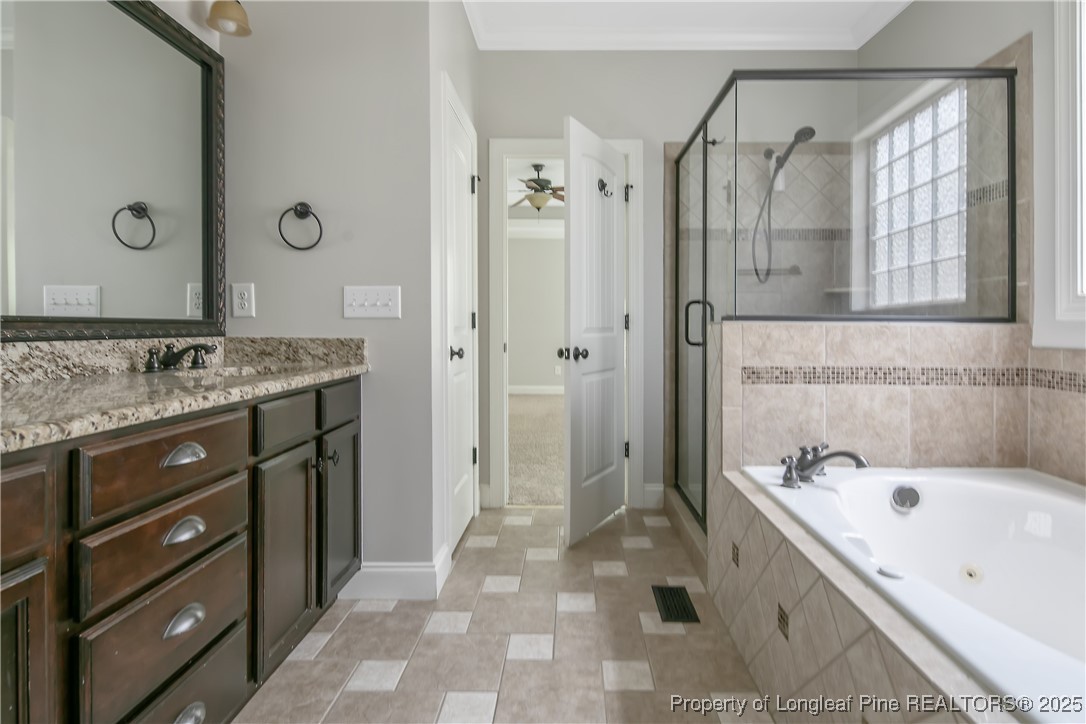 716 Micahs Way North Spring Lake, NC 28390 - Photo 32 of 50 a bathroom with a tub sink and mirror