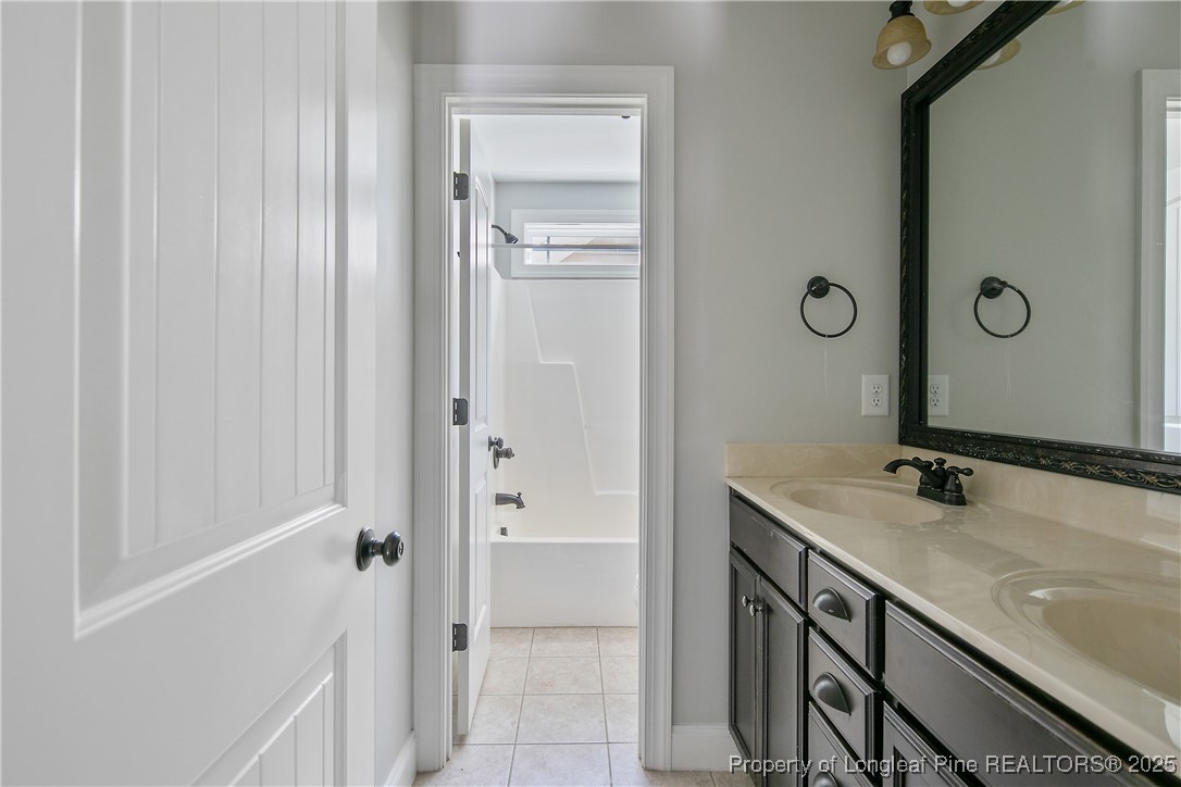 716 Micahs Way North Spring Lake, NC 28390 - Photo 40 of 50 a bathroom with a sink and a mirror